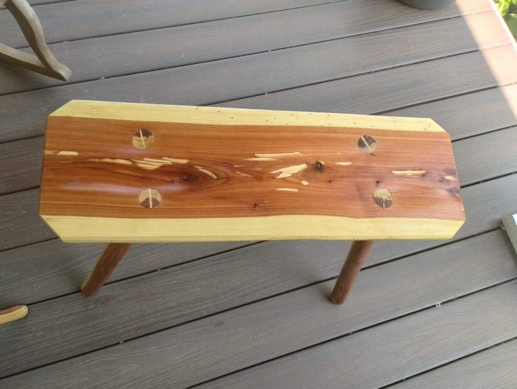 Medieval inspired riven wood benches for stone-walled entryways